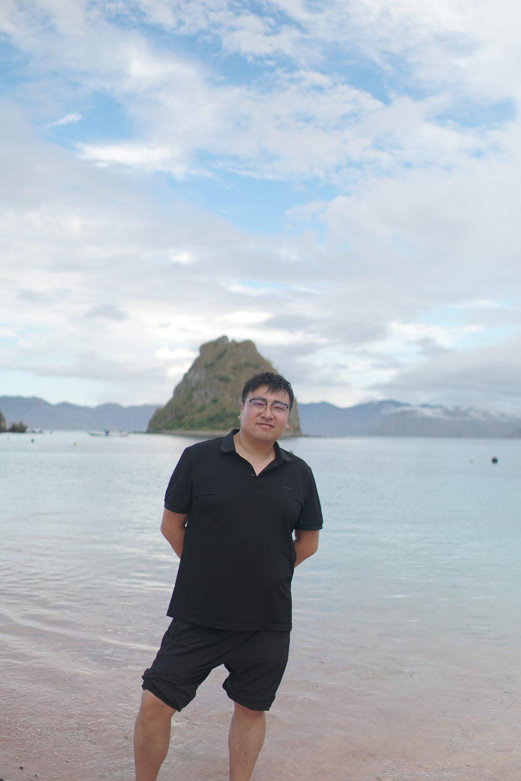 Kelor – man standing in shallows, islet behind (Real photo from a KEXI trip)