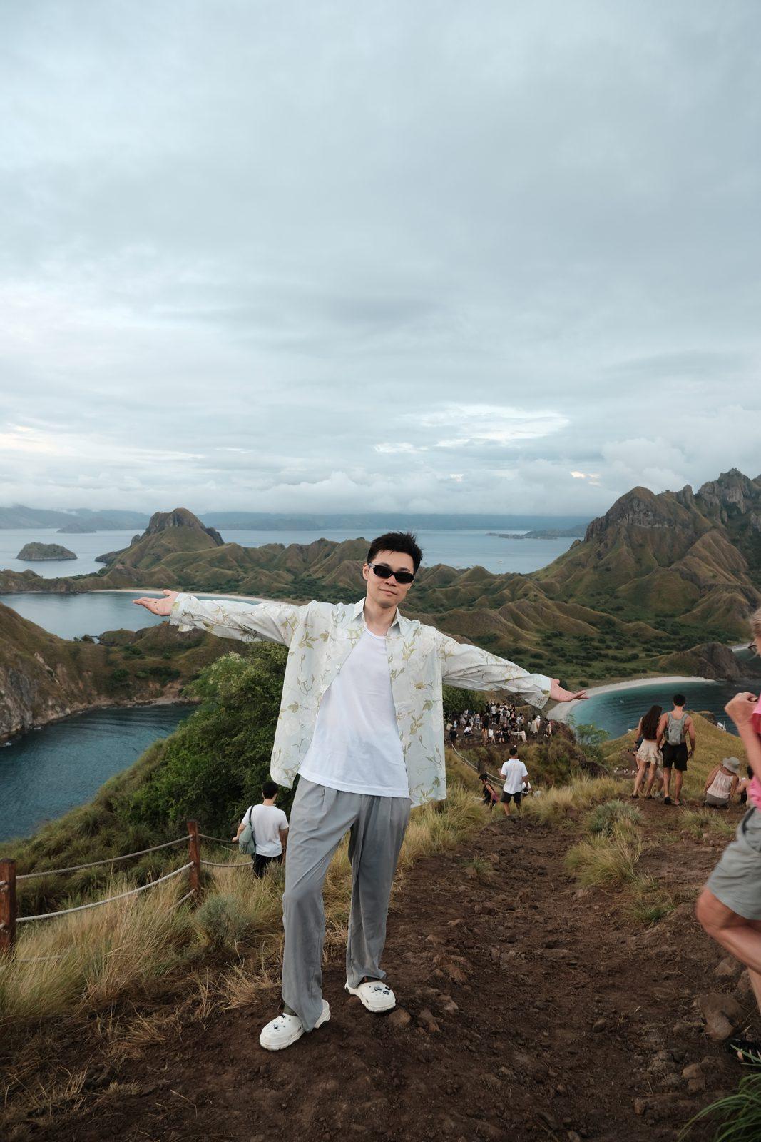 Padar – Man arms outstretched on Padar ridge (Real photo from a KEXI trip)