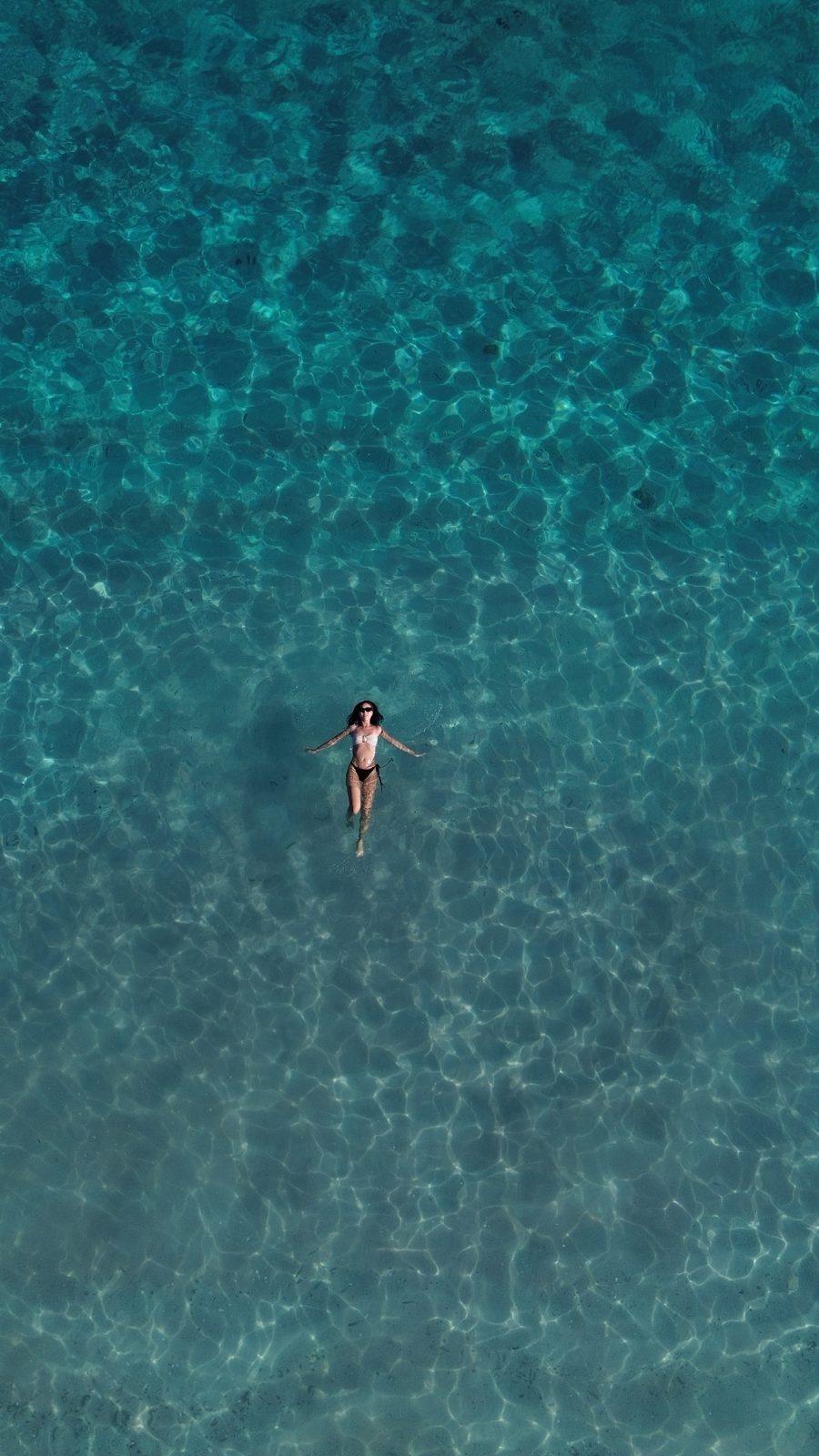 Swim Snorkel – aerial single swimmer in turquoise water (Real photo from a KEXI trip)